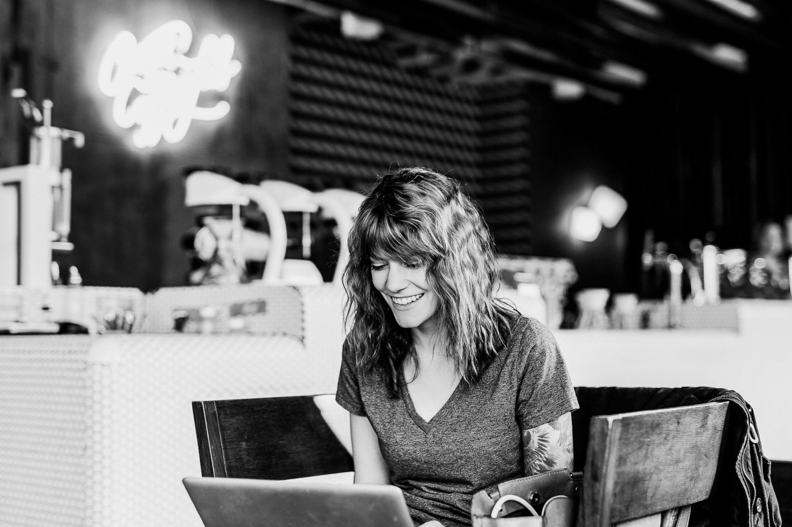 Woman working remotely in a cafe with laptop